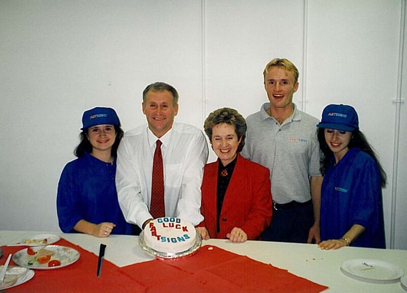 An image of the FASTSIGNS team celebrating their opening in 1995.